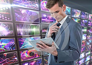 Businessman holding tablet with colorful screens visuals