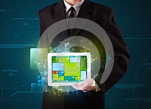 Businessman holding a tablet with modern software operational sy