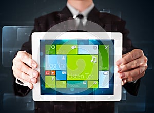 Businessman holding a tablet with modern software operational system