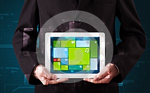 Businessman holding a tablet with modern software operational system