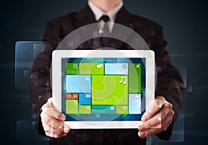 Businessman holding a tablet with modern software operational system