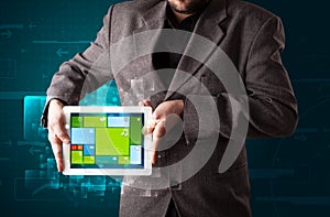 Businessman holding a tablet with modern software operational system