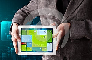 Businessman holding a tablet with modern software operational system