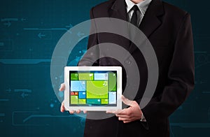 Businessman holding a tablet with modern software operational system