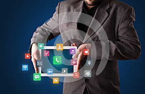 Businessman holding tablet with multimedia concept