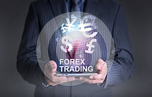 Businessman holding tablet world of currency forex trading