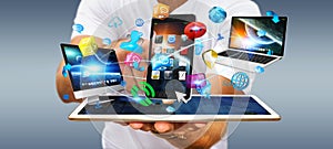 Businessman holding tech devices and icons applications