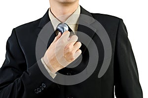 Businessman holding a tie