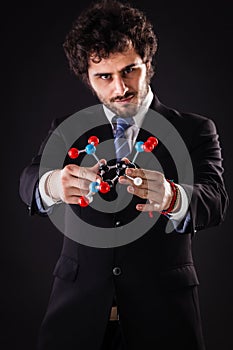 Businessman holding a tnt molecular structure