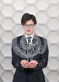 Businessman holding tree