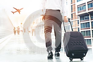 Businessman holding trolley bag going up on travel