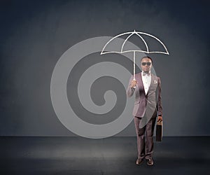 Businessman holding an umbrella.