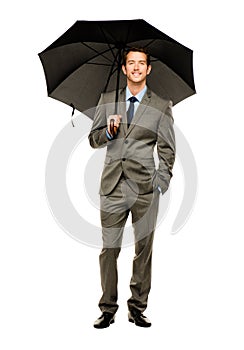 Businessman holding umbrella smiling isolated white background
