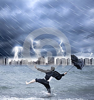 Businessman holding an umbrella with thundershower