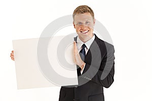 Businessman holding up blank poster