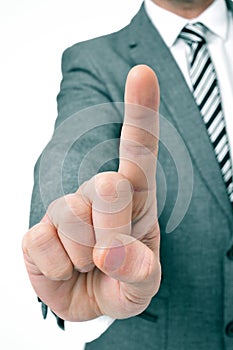 Businessman holding up his index finger