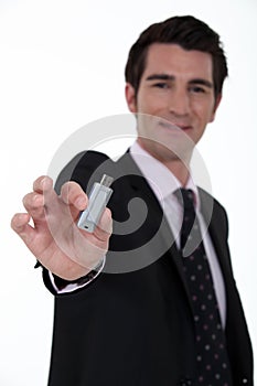 Businessman holding a USB key.