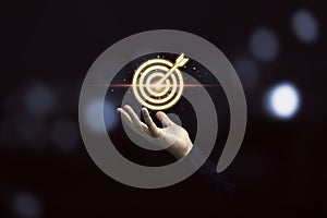 Businessman holding virtual golden target dartboard for Focus and achievement business objective concept