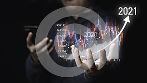 Businessman holding virtual stock market chart and graph for analysis , Value investment and trading concept