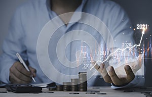 Businessman holding virtual stock market chart and graph for analysis , Value investment and trading concept