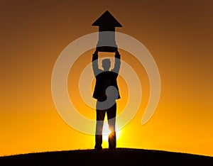 Businessman Holding The Way Forward Sign