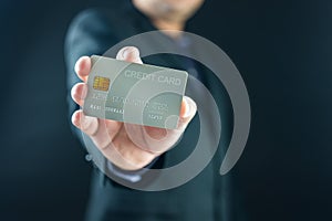 Businessman holding a white credit card while standing. Mock up copy space