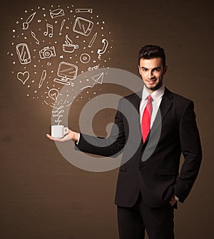 Businessman holding a white cup with social media icons