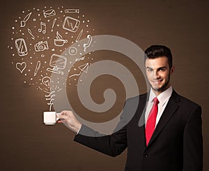 Businessman holding a white cup with social media icons