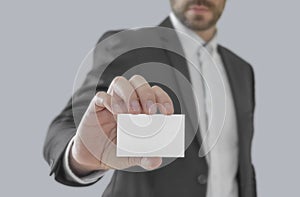 Businessman holding white paper visit card