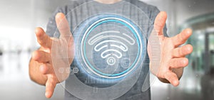 Businessman holding Wifi icon with stats and binary code 3d rendering