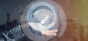 Businessman holding Wifi icon with stats and binary code 3d rendering