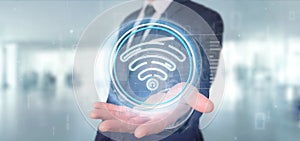 Businessman holding Wifi icon with stats and binary code 3d rendering