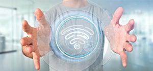 Businessman holding Wifi icon with stats and binary code 3d rendering