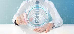 Businessman holding Wifi icon with stats and binary code 3d rendering