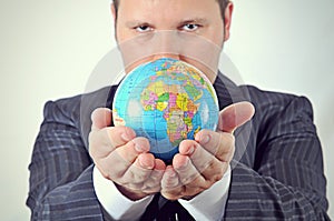 Businessman is holding the world