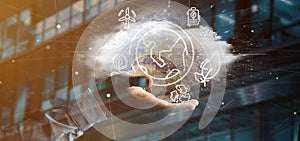 Businessman holding a World globe surronding by ecology icons an photo