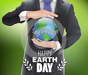 Businessman holding the world in hand with green background