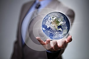 Businessman holding the world in his hands