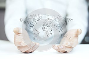 Businessman holding world map in hands