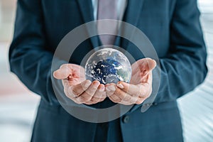 Businessman is holding world sphere. concept of beeing connected and ruling the world, global domination. Elements of