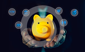 Businessman holding yellow piggy bank with icons of planning family life