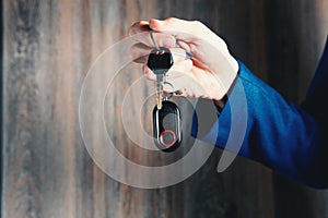 businessman holds car keys in his hands