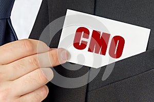 Businessman holds a card with the text - CMO