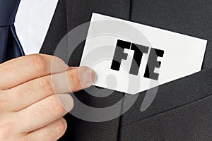 Businessman holds a card with the text - FTE