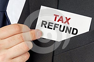 Businessman holds a card with the text - TAX REFUND