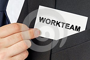 Businessman holds a card with the text - WORKTEAM