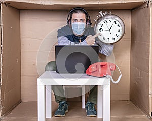 Businessman holds a clock and informs you about being late photo