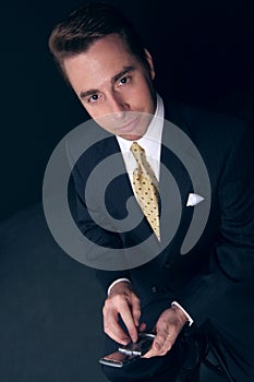 Businessman holds his cell phone
