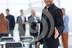 Businessman holds out his hand for a handshake