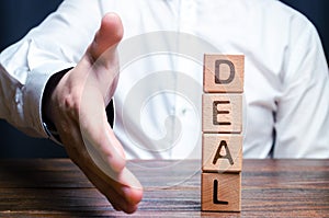 The businessman holds out his hand to make a deal. Concept of a contract or deal, making an offer. Signing or renewing a contract